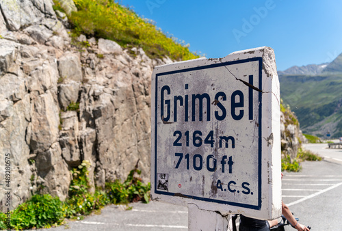 Grimselpass, Switzerland - August 13, 2021: The signpost at Grimsel Pass, a mountain pass in Switzerland, crossing the Bernese Alps at an elevation of 2164 metres.