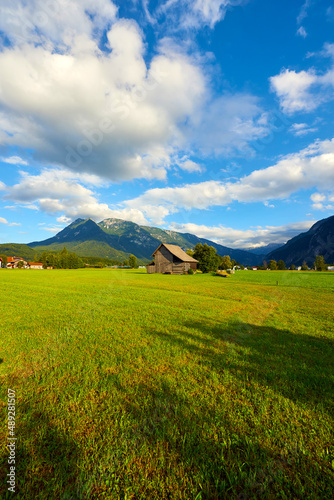 Beautiful Austrian Landscape with agricultural field, old barn and mountains. Bad Goisern, Upper Austria. 