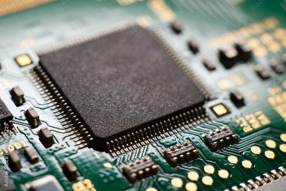 Macro photo of a green computer printed circuit board with selective focus on an blank chip. Macro photo of a green computer printed circuit board with selective focus on an blank chip.