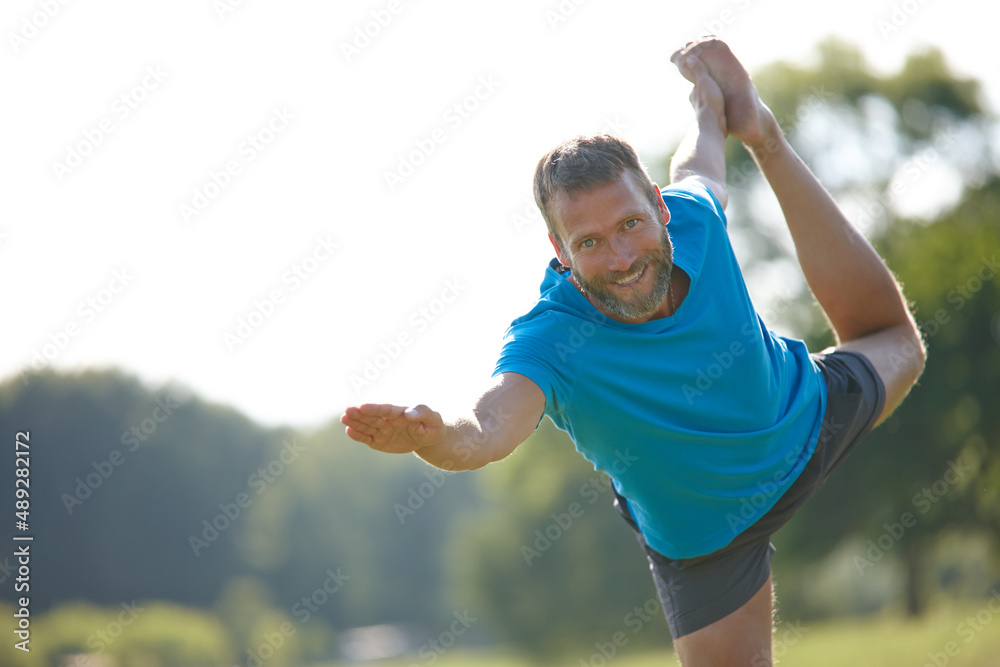 © D Laflor/peopleimages.com - Its my favorite position. Cropped shot of a handsome mature man doing yoga outdoors. © D Laflor/peopleimages.com - Its my favorite position. Cropped shot of a handsome mature man doing yoga outdoors.