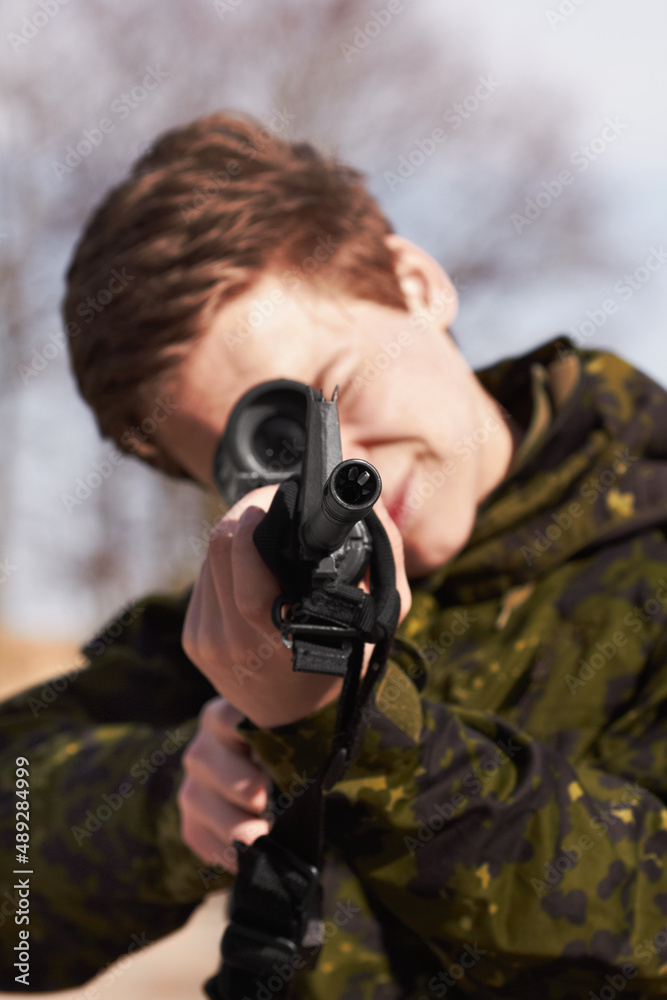 Perfect aim. A young soldier aiming his rifle at you. Perfect aim. A young soldier aiming his rifle at you.
