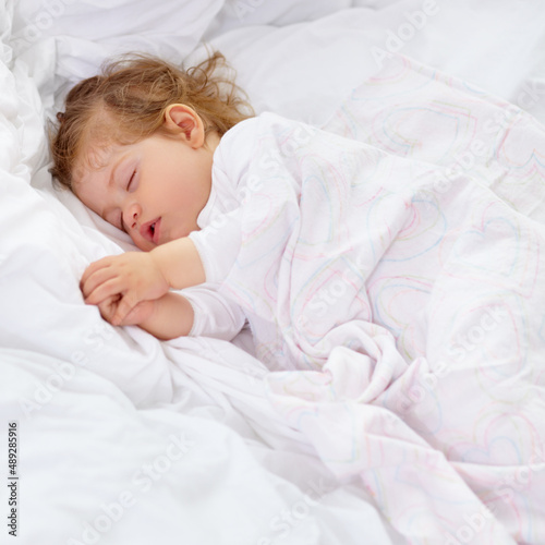 Sleep is important for development. A cute baby sleeping on the bed. © C Mcdonald/peopleimages.com