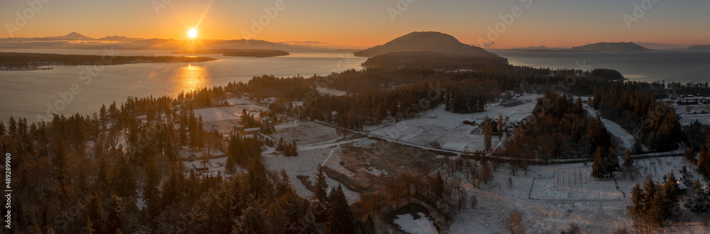 Aerial View Of a Snowy Sunrise Landscape on Lummi Island, Washington. Drone shot of this small island in the Salish Sea area in close proximity to Bellingham, Washington.