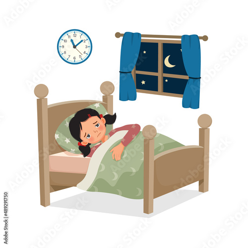 cute little child girl has insomnia or sleeping disorder stay awake and cannot sleep on bed at night in bedroom