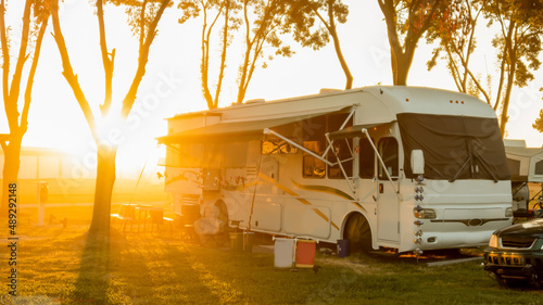 Rv Camping with sun rising or setting behind motorhome