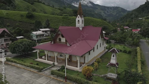 Rising aerial of quaint Iglesia de Prusia church in remote Peru valley photo