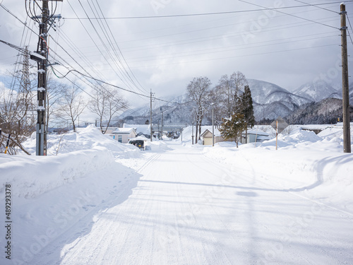 empty snow-covered street and wheel trucks in nagano © Yuichi Mori