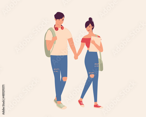 Young Student Couple With Ripped Jeans Walking And Holding Hands Together.