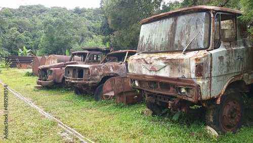 two old cars One of the trucks rusted, used in the mines. parked on the green lawn