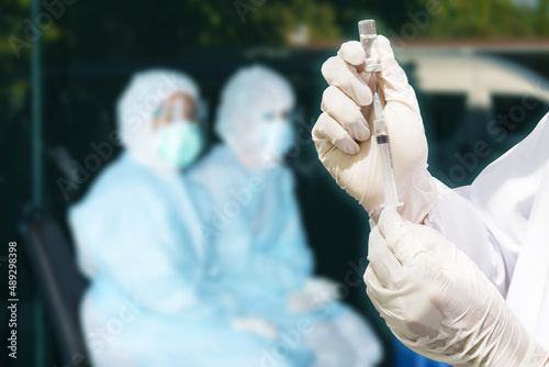 Doctor's hand holding a syringe, Concept fight against virus covid-19 coronavirus