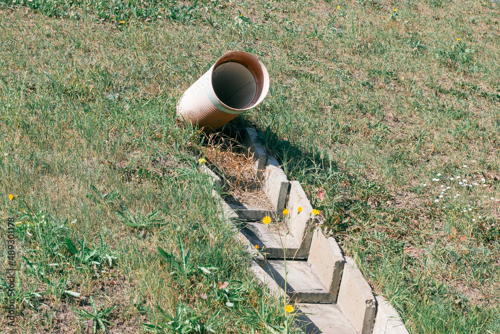 Fototapeta premium Drainpipe coming out of the ground