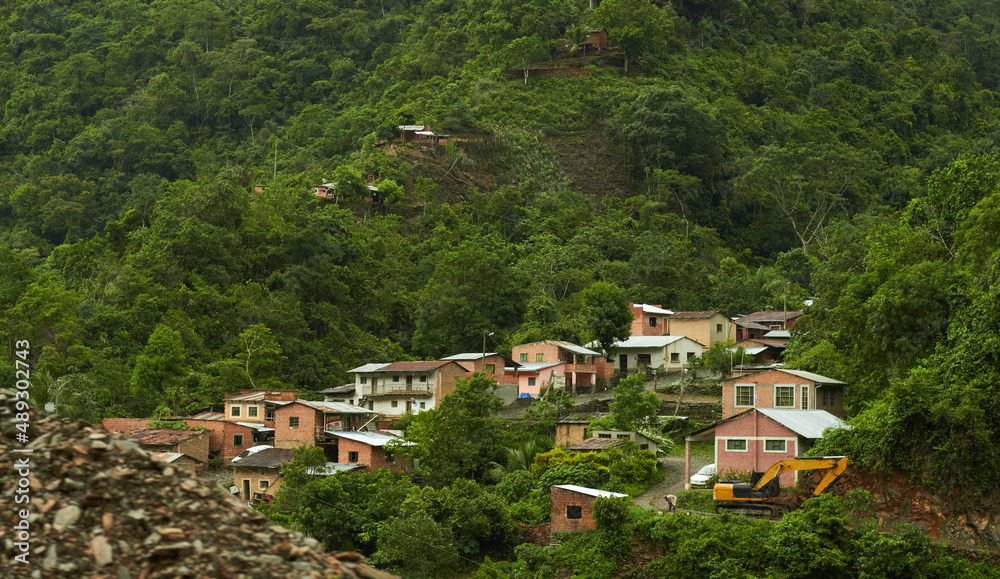 Small houses surrounded by forested hills