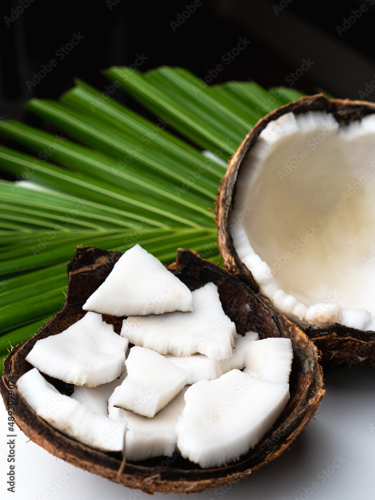 Coconut meat and coconut leaf on white table. Coconut meat and coconut leaf on white table.