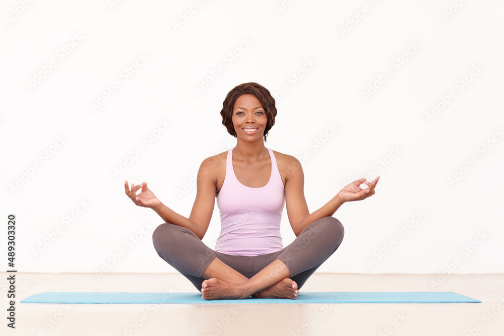 Enjoying a yoga session. A young african-american woman relaxing with a yoga routine. Enjoying a yoga session. A young african-american woman relaxing with a yoga routine.