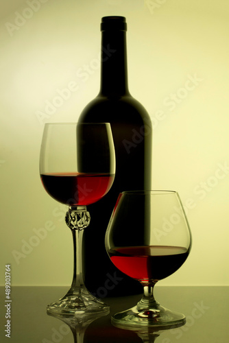 Still life with glass bottle and wine glasses
