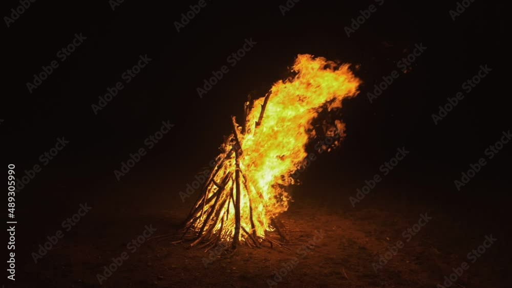 Silhouette of mystic woman in black background of fire fly flame, spark, of contour outline. Adult sexy of young girl witchcraft ceremony ritual dance in underclothes. Outdoor slow motion. Caucasian.