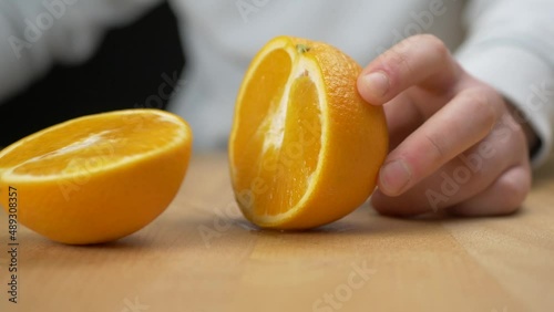 Cutting fruit in half with a sharp knife photo