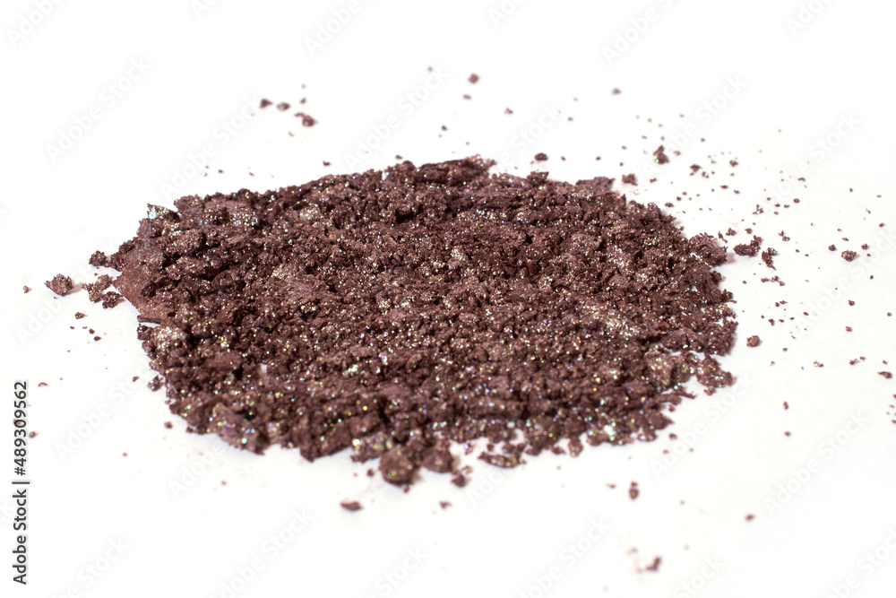 Scattered brown eye shadow isolated on a white background Scattered brown eye shadow isolated on a white background