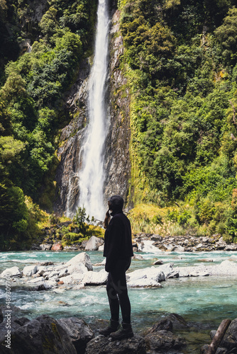 woman looking at waterfall in the forest