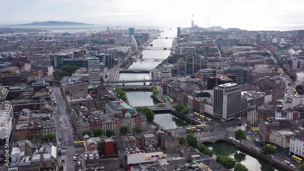 Daytime in the middle of Dublin’s busy city centre. Overlooking the river Liffey as it meets the sea. The flyover shows a dull sky with clouds covering most of it. Daytime in the middle of Dublin’s busy city centre. Overlooking the river Liffey as it meets the sea. The flyover shows a dull sky with clouds covering most of it.