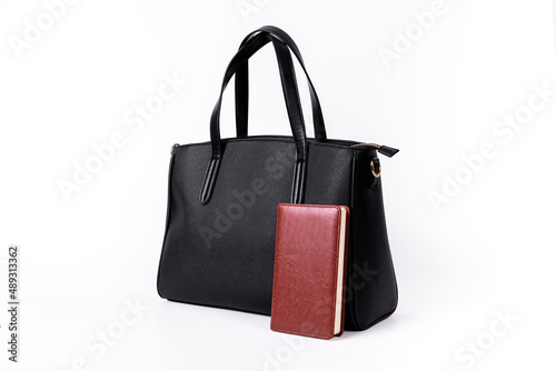 A black leather bag shows what you can hold on a white background