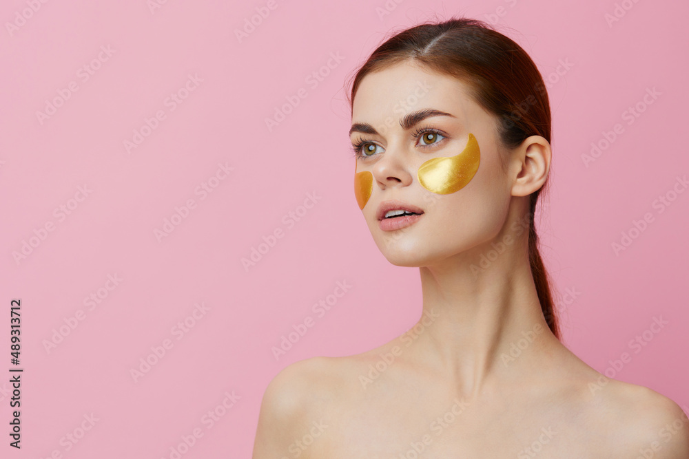 pretty woman skin care face patches bare shoulders hygiene pink background pretty woman skin care face patches bare shoulders hygiene pink background