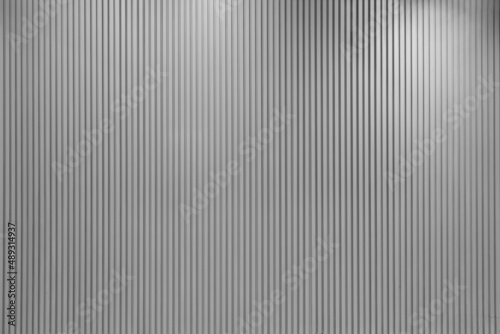 Fototapeta Naklejka Na Ścianę i Meble -  Vertical line textured grey wall with lights hitting it from different angles