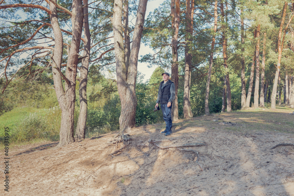Man nature photographer taking pictures in the forest. Man nature photographer taking pictures in the forest.