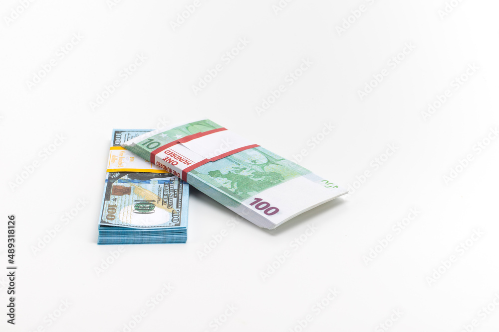 Two Packs of European and US Banknotes Currencies Placed Together on White Background Two Packs of European and US Banknotes Currencies Placed Together on White Background