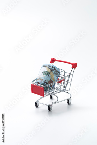 Financial Concepts. One Shopping Trolley With Dollars Currency Banknote On White. Concept of Shopping and Savings. © danmorgan12