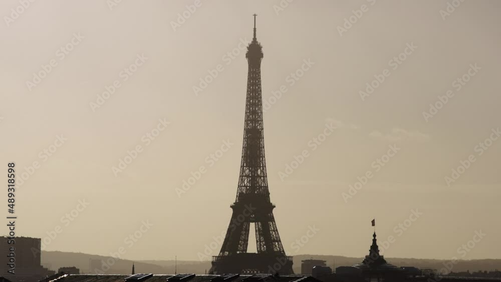 Beautiful view of Eiffel tower during golden hour with city haze Slow Motion 4k 30p