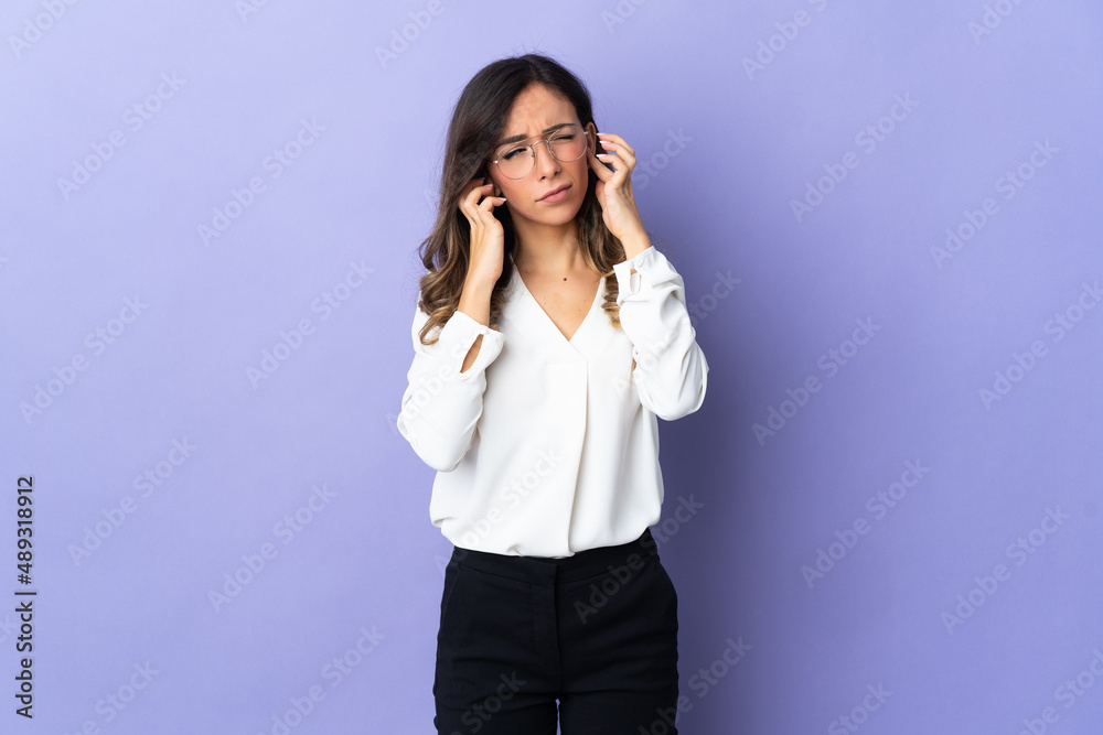 Young caucasian woman isolated on purple background frustrated and covering ears Young caucasian woman isolated on purple background frustrated and covering ears