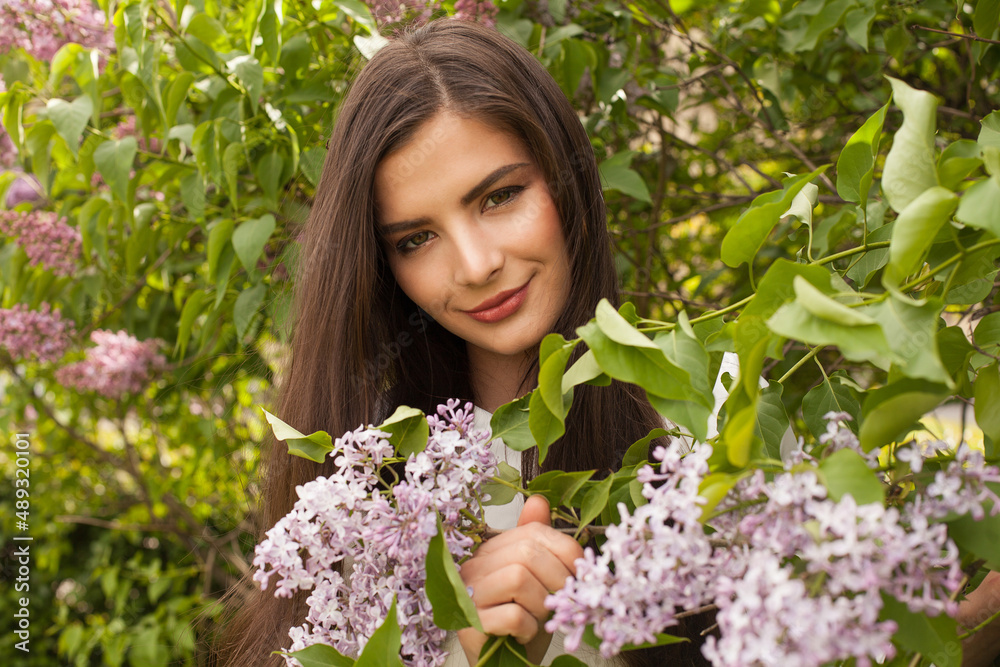 Beautiful young woman with dark hair with spring flowers Beautiful young woman with dark hair with spring flowers