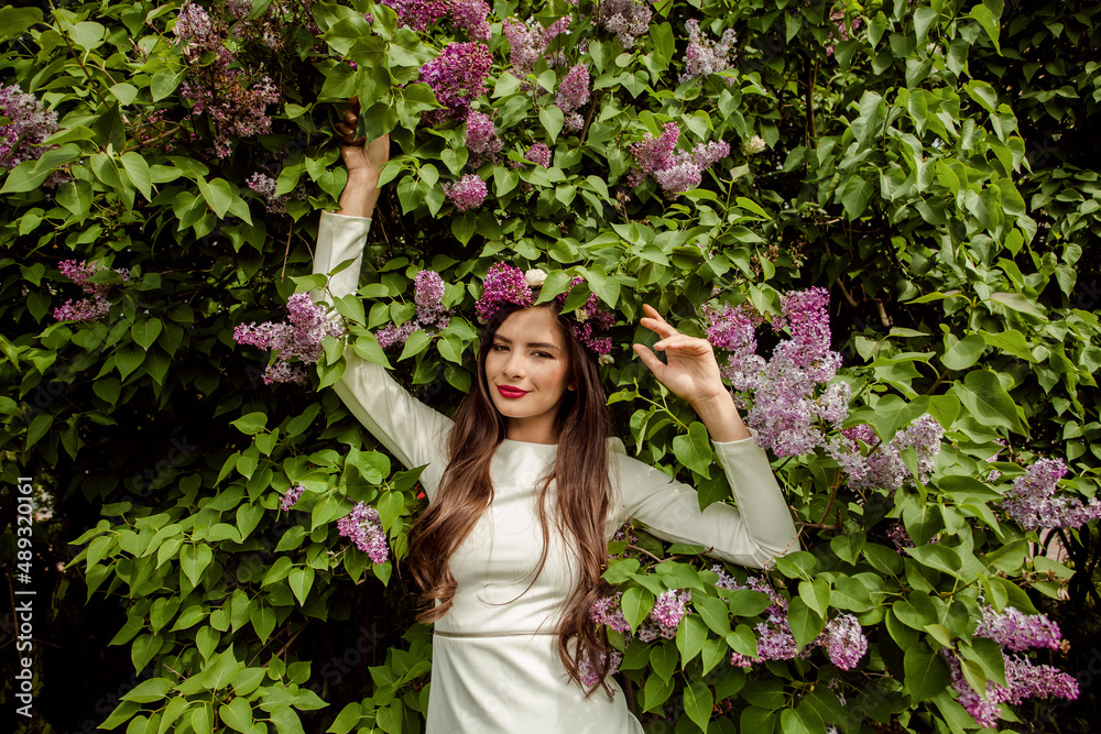 Happy woman relaxing on spring flower and green leaves background Happy woman relaxing on spring flower and green leaves background