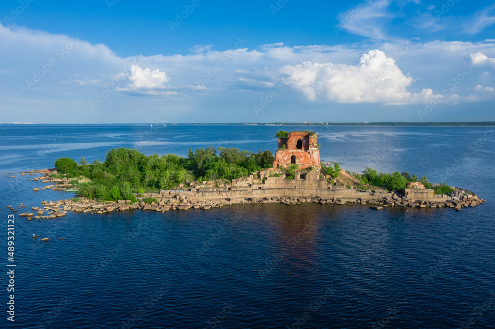 View from the height of the fort Emperor Paul 1 in Kronstadt, the Gulf of Finland, the island of forts, a ruined red brick building in the Gulf of Finland.