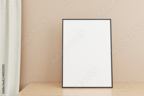 Minimalist and clean vertical black poster or photo frame mockup on the wooden table in living room