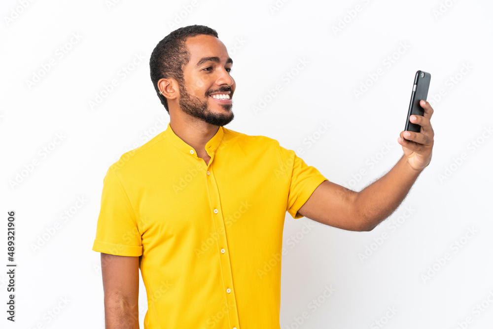Young Ecuadorian man isolated on white background making a selfie Young Ecuadorian man isolated on white background making a selfie