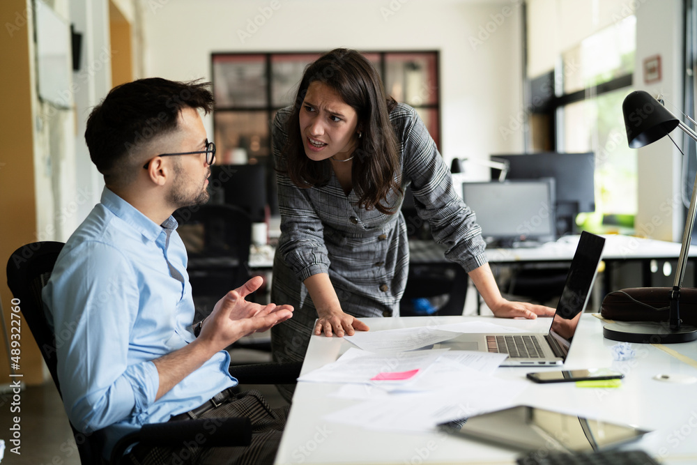 Colleagues arguing in office. Angry businesswoman yelling at her collegue. Colleagues arguing in office. Angry businesswoman yelling at her collegue.
