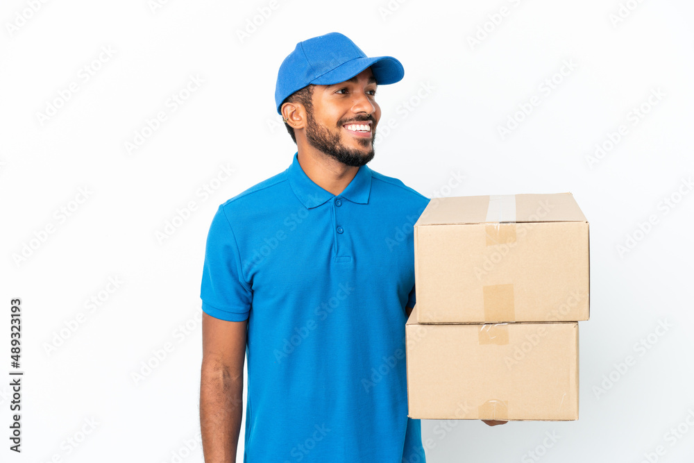 Delivery Ecuadorian man isolated on white background looking side Delivery Ecuadorian man isolated on white background looking side
