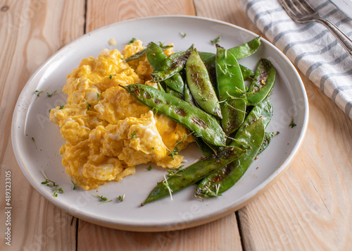 Scrambled eggs with buttered sugar snap peas