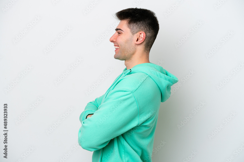 Young caucasian man isolated on white background in lateral position