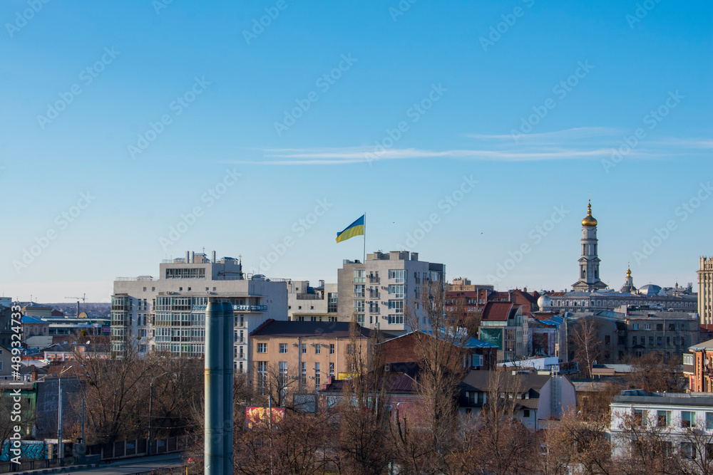 Ukrainian flag on a flagpole in Kharkov, Ukraine. The photo was taken on February 24, 2022 on the first day of Russia's attack on Ukraine.