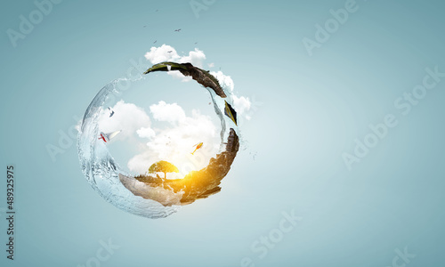 Green sphere landscape with grass and clear water photo