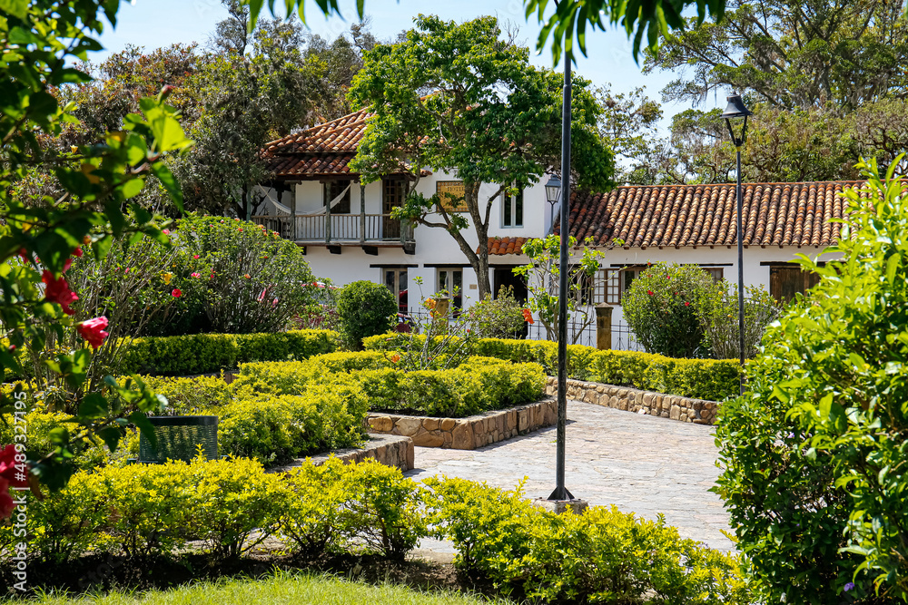 Neat park area with a traditional building in the back on a sunny day, Villa de Leyva, Colombia
