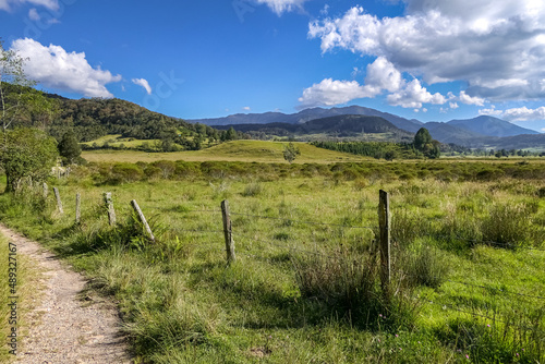 Rural scenery with green grass and mountains in backglround on a sunny day, Villa de Leyva, Colombia