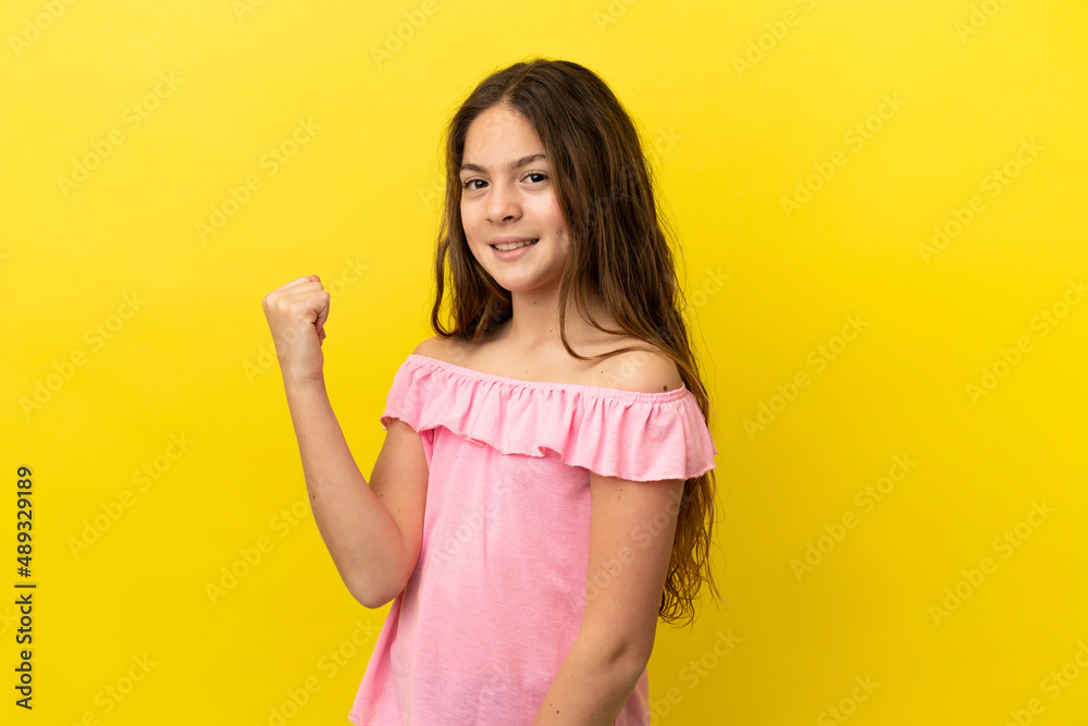 Little caucasian girl isolated on yellow background celebrating a victory Little caucasian girl isolated on yellow background celebrating a victory
