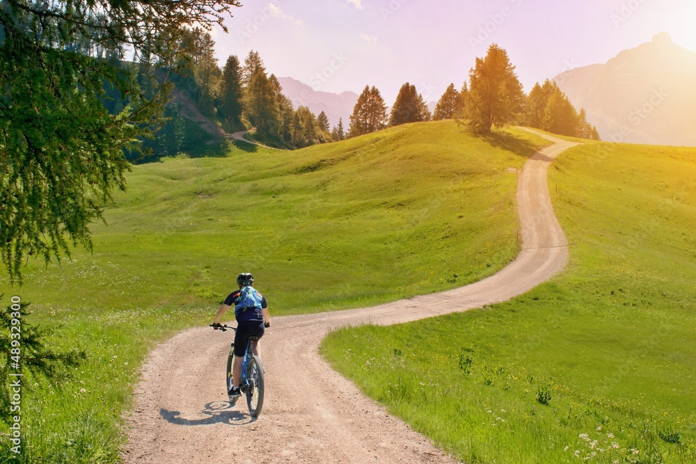 Fototapeta premium Biker riding scenic path in beautiful summer mountain scenery , Dolomites Italy, European Alps.