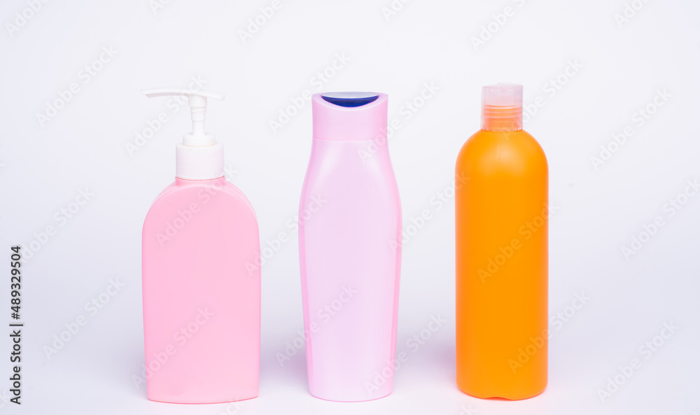 Refillable shower and bath gel product containers in row isolated on white copy space, bottles Refillable shower and bath gel product containers in row isolated on white copy space, bottles