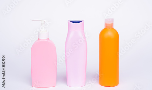 Refillable shower and bath gel product containers in row isolated on white copy space, bottles