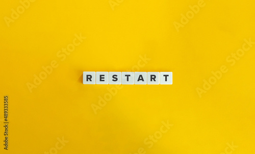 Restart Word on Letter Tiles on Yellow Background. Minimal Aesthetics.
